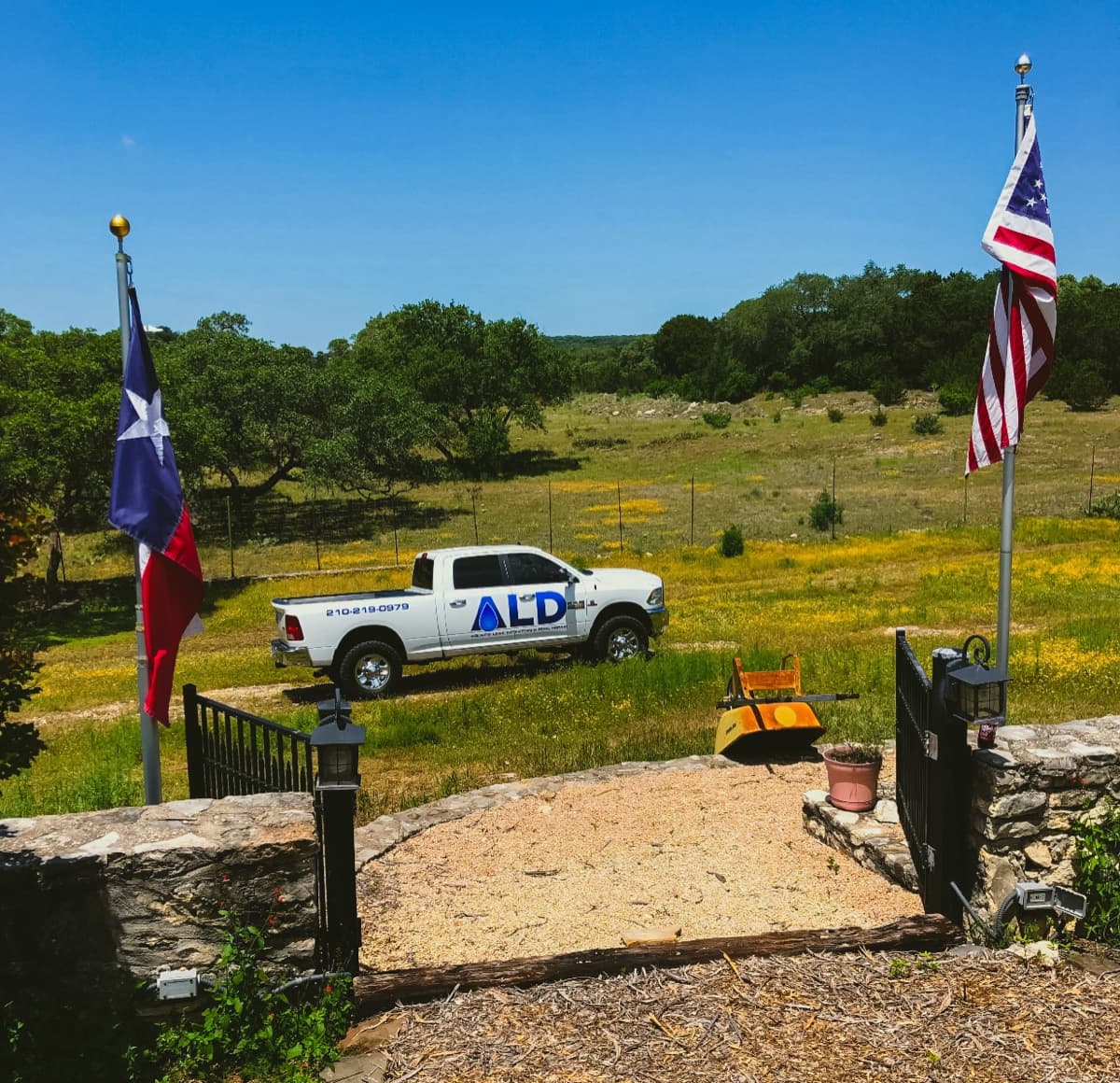 Aquatic Leak Detection truck with Texas and American flags in the Texas Hill Country